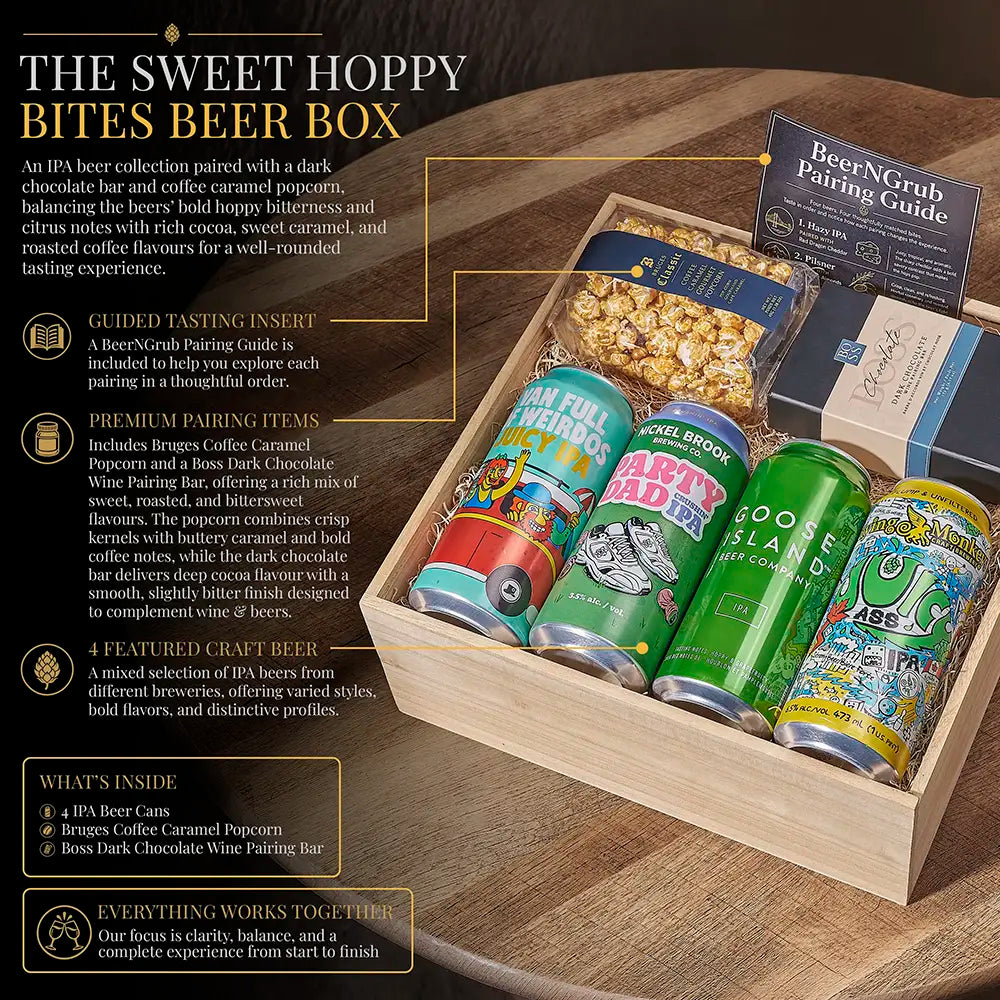 A curated beer gift box set displayed in a wooden tray, featuring four colorful IPA craft beer cans, a bag of popcorn, a chocolate-coated wine pairing bar, and a BeerNGrush Trading Guide. The scene is styled with promotional text overlays on a dark background.