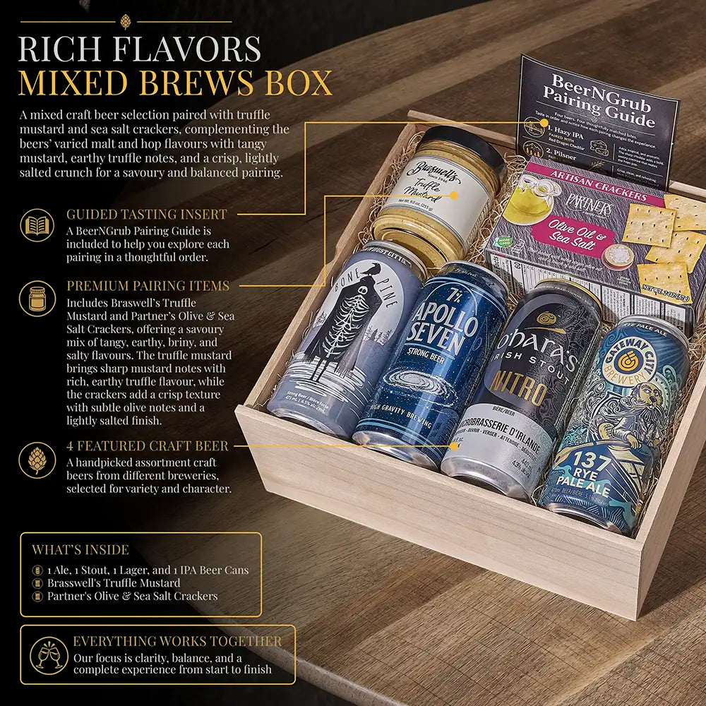 A beer gift box set labeled 'Rich Flavors Mixed Brews Box' displayed on a wooden tabletop. The open wooden crate contains multiple craft beer cans, a beer pairing guide, and several packaged condiment packets.