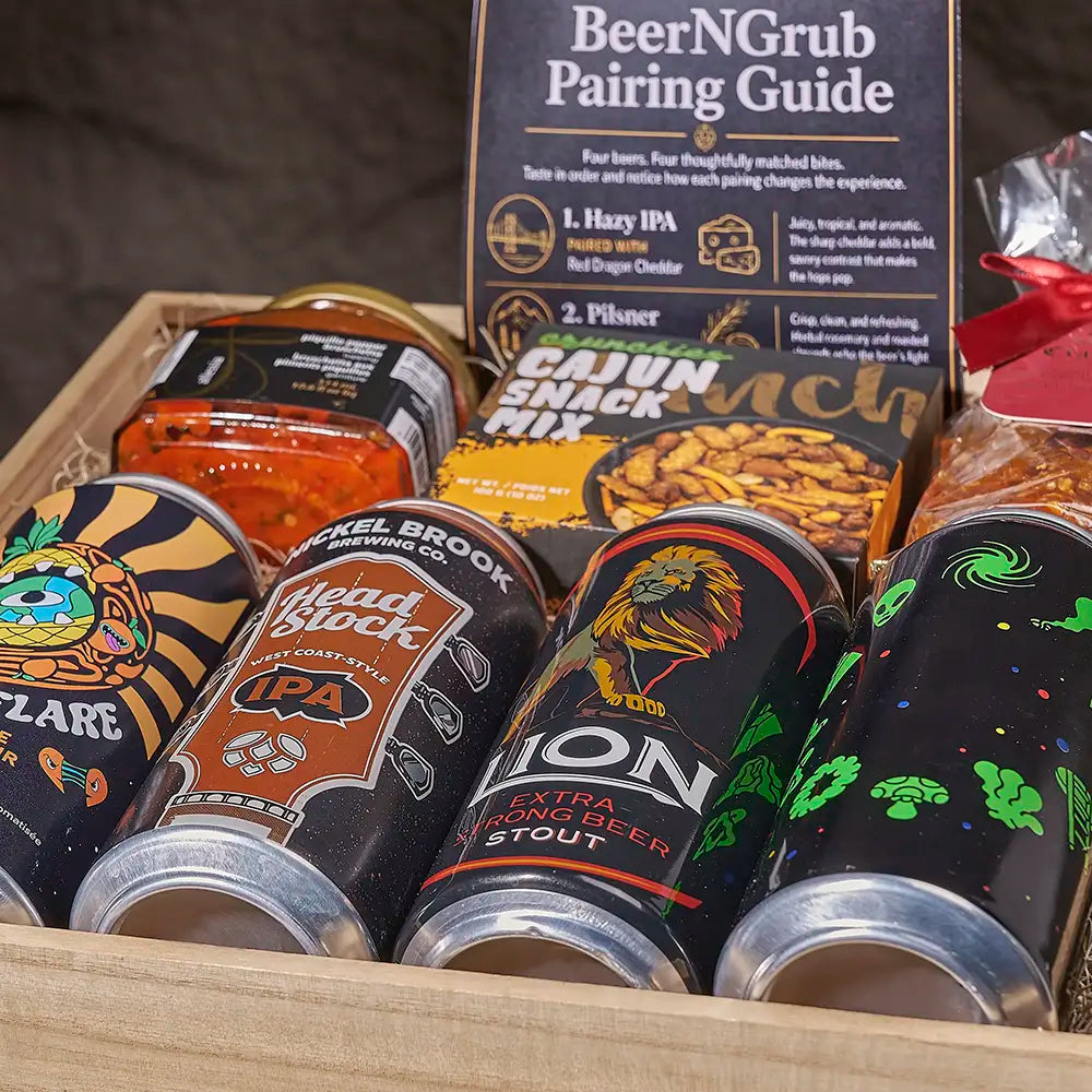 A curated beer and snack gift box labeled 'BeerGrub Pairing Guide' with multiple beverage and snack items arranged in a wooden tray. Visible products include cans of Pelkel Brook Brewing Co.